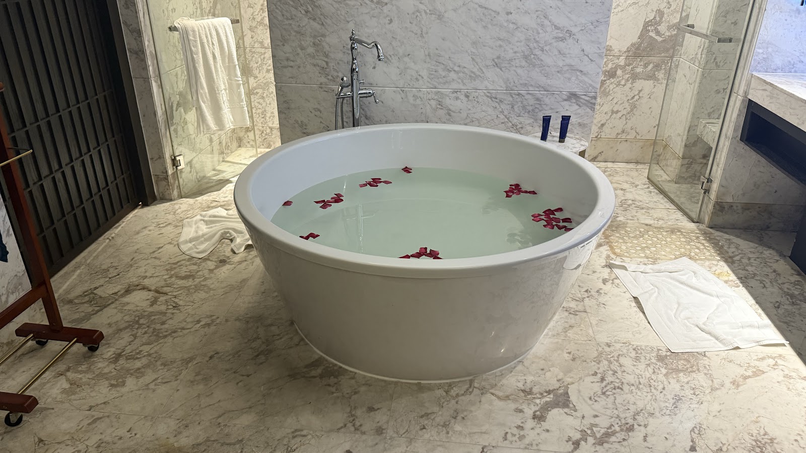A marble bathroom with a freestanding round tub, completed by South Hampshire Builders